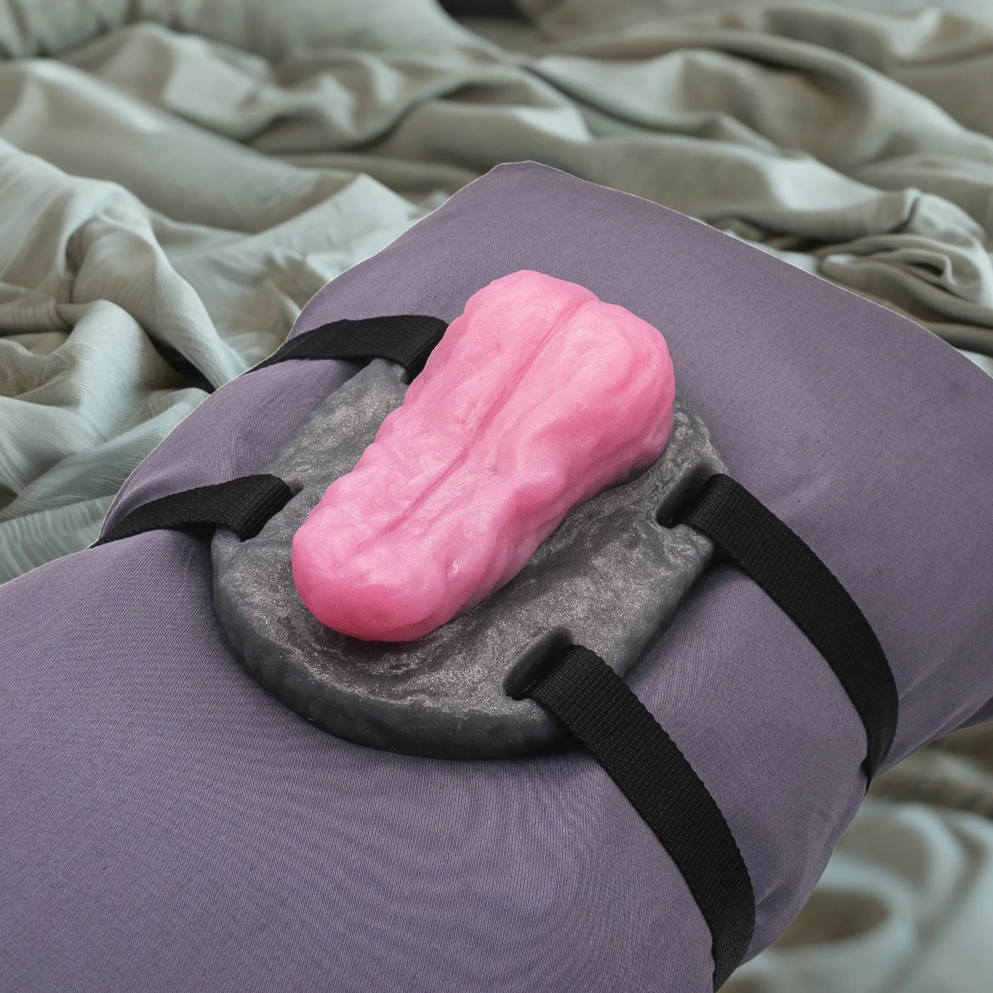Lingus Tongue Sex Toy Grinder on a pillow