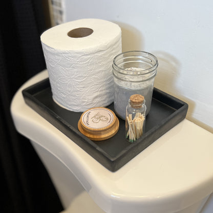 silicone tray on back of toilet organizing toiletries 